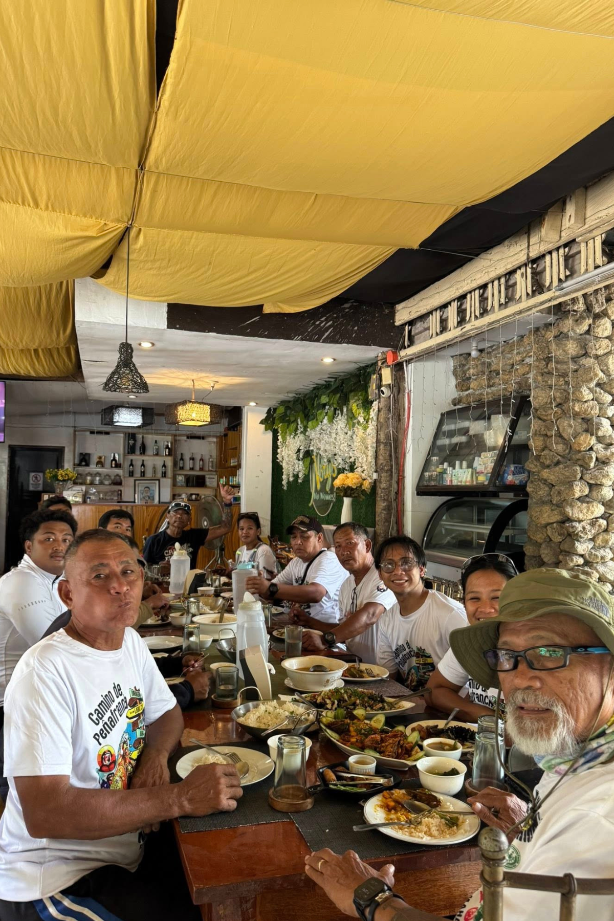 Hungry pilgrims having lunch at a roadside pit stop on the way to Ligao City.