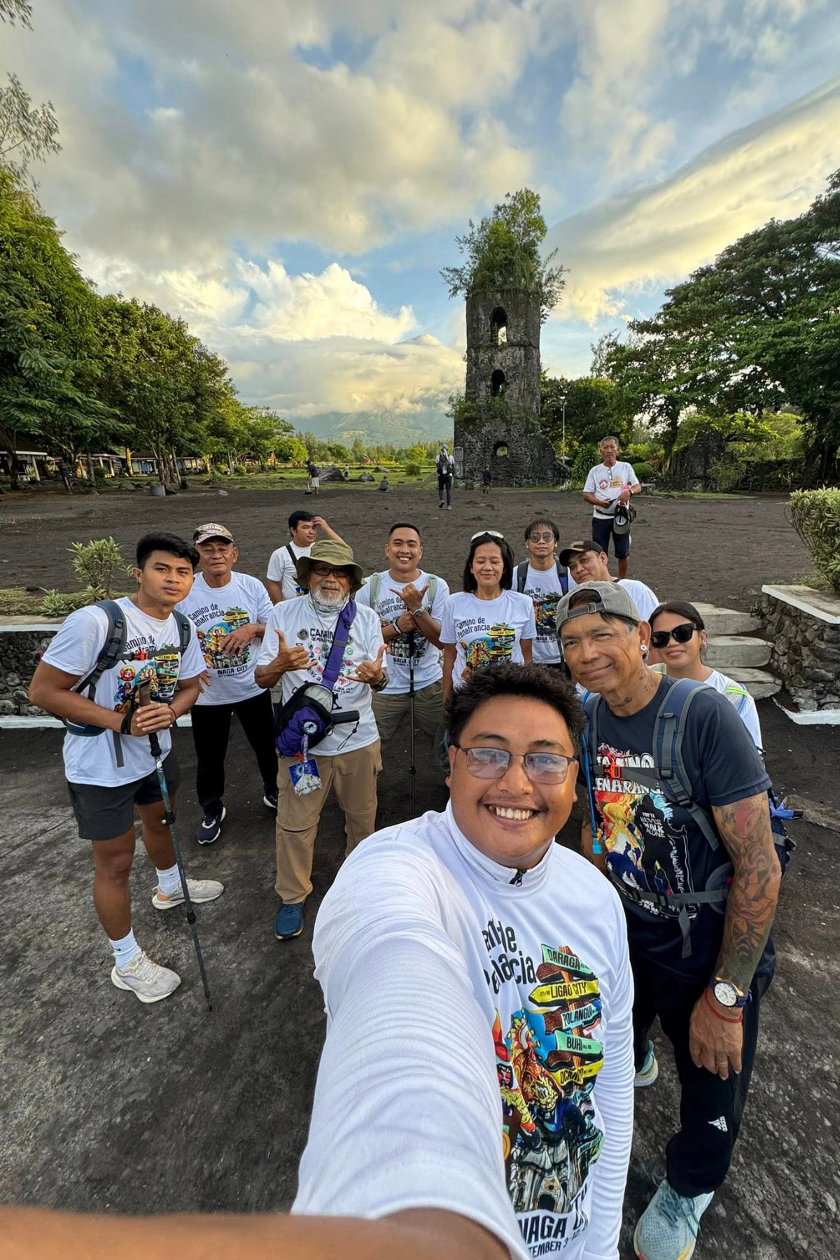Visitors at the iconic Cagsawa Ruins in Daraga, Albay, with the historic church tower and Mayon Volcano in the background.